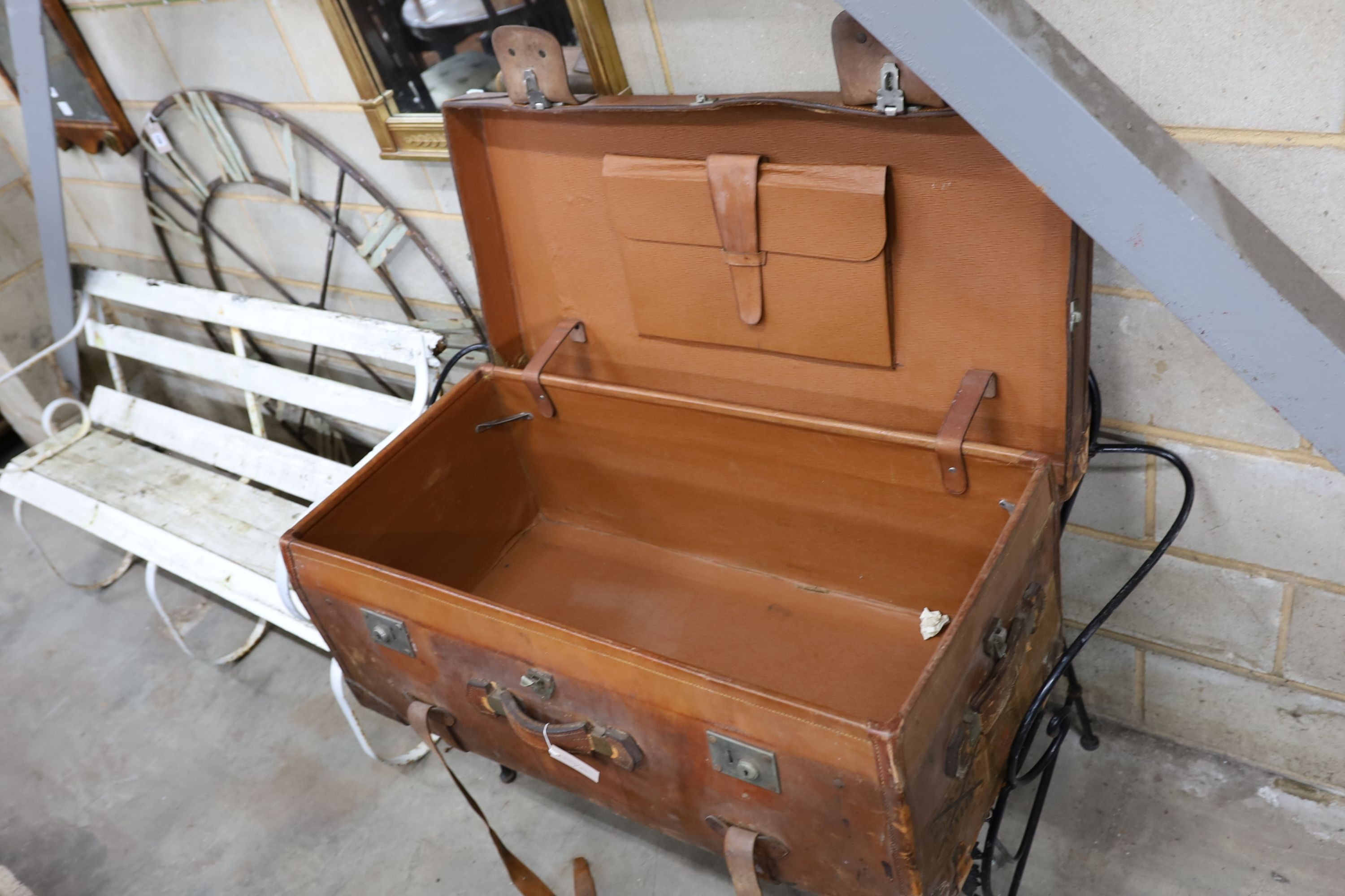 An early 20th century large tan leather trunk with labels, length 100cm, depth 53cm, height 39cm